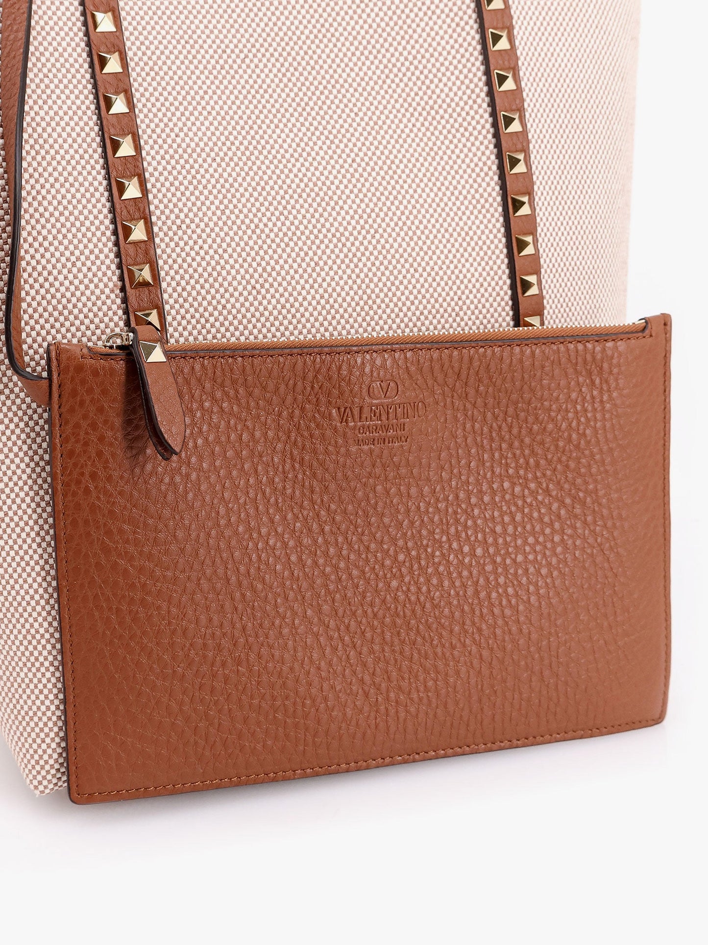 Borsa a tracolla in pelle e canvas con iconiche borchie