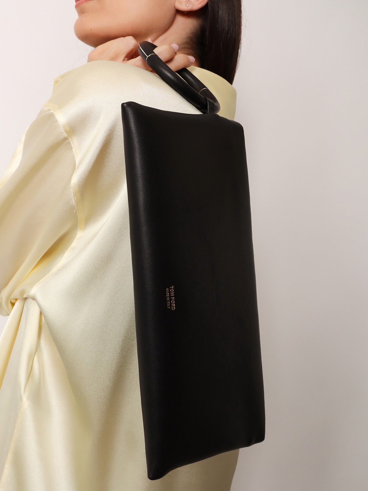Aura leather clutch bag with lettering logo on the front