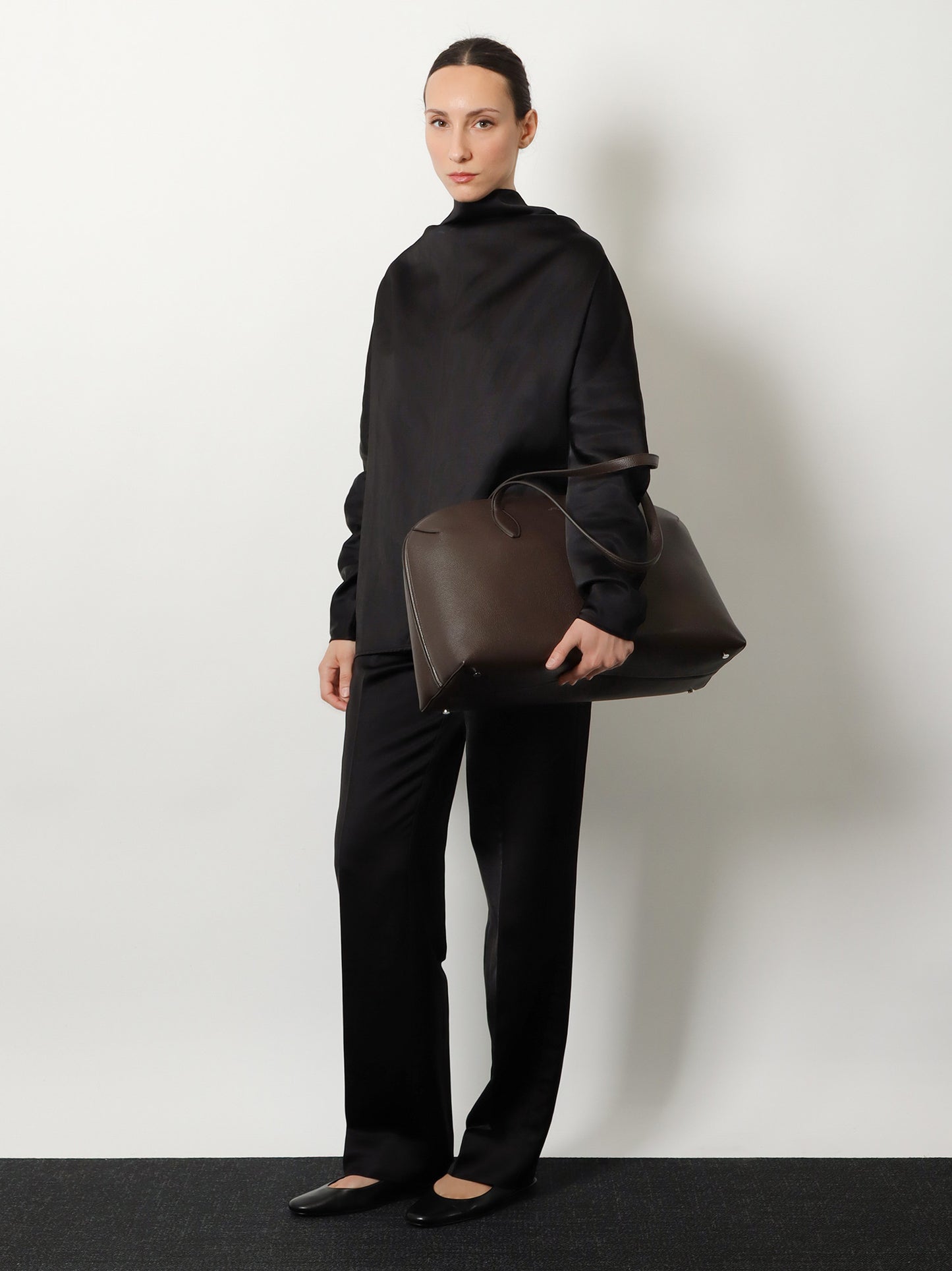 Suede handbag with engraved logo on the front